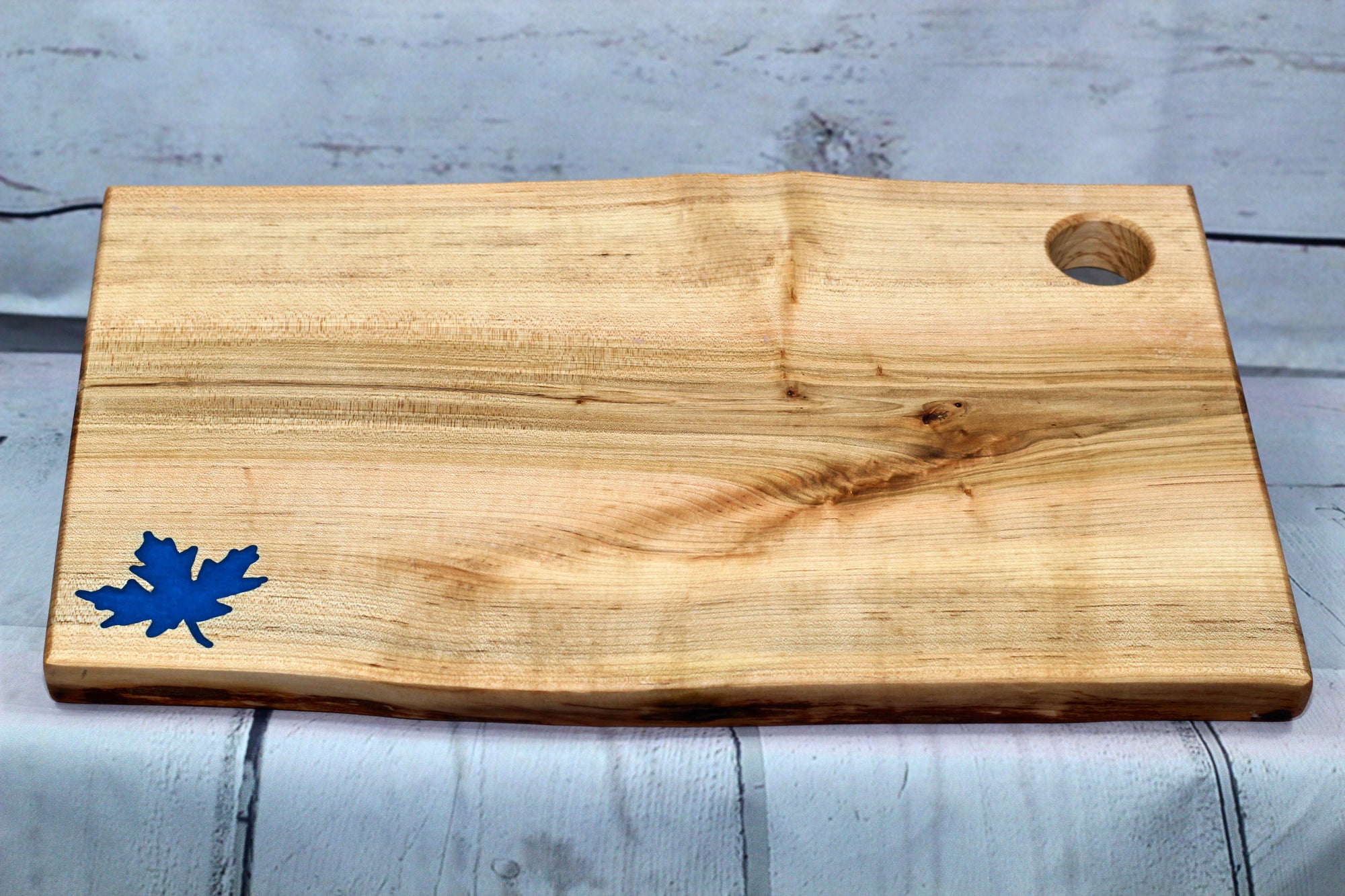 Charcuterie board (live edge maple with blue epoxy leaf)